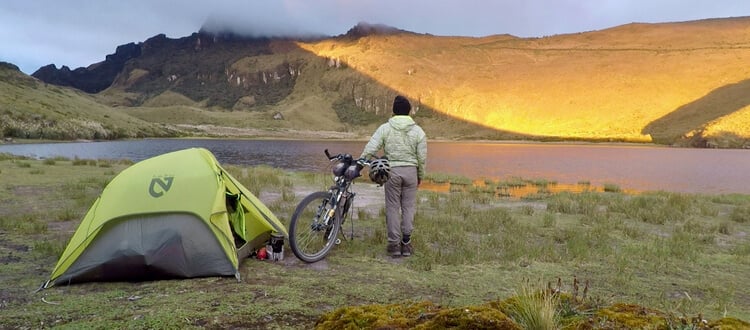 Using a tent that is adaptable for hiking and bicycle touring 