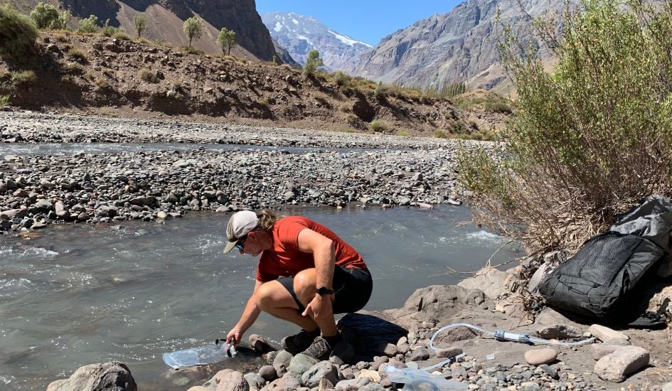 Filling a hiking gravity filter bladder in a mountain stream